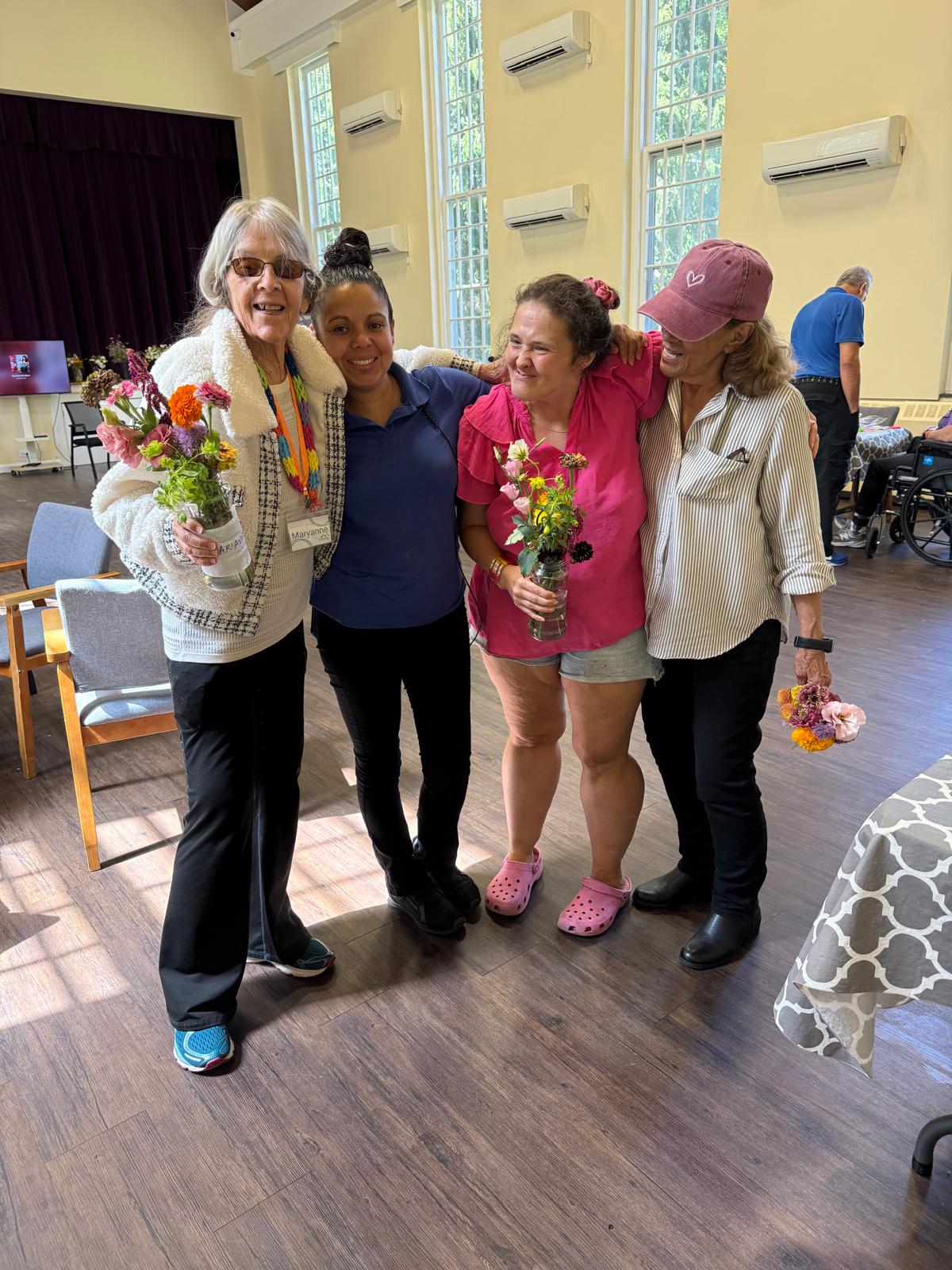 Members showing off flower arrangements they made together