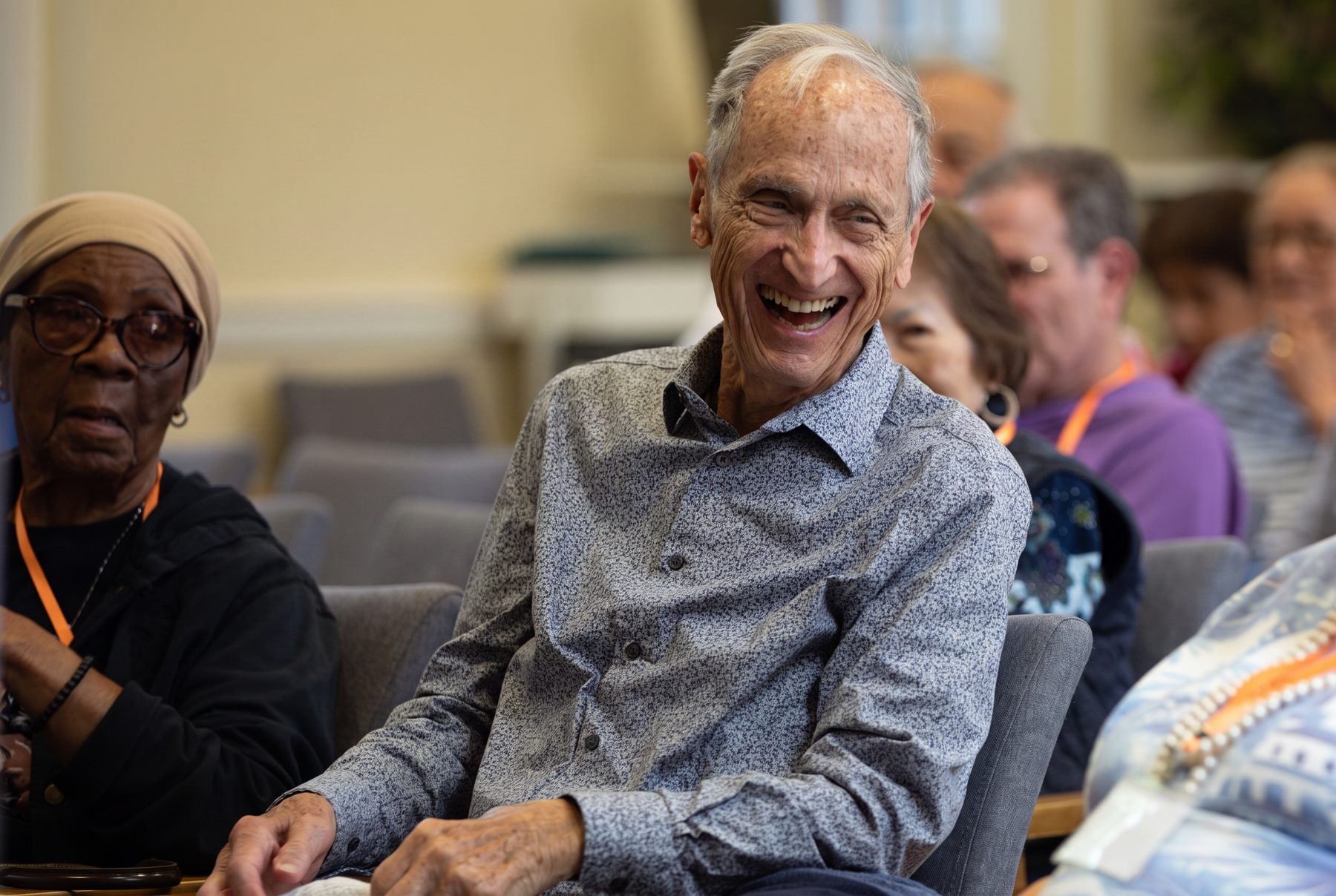 An Evergreen member laughing during a morning program in the Stamford studio