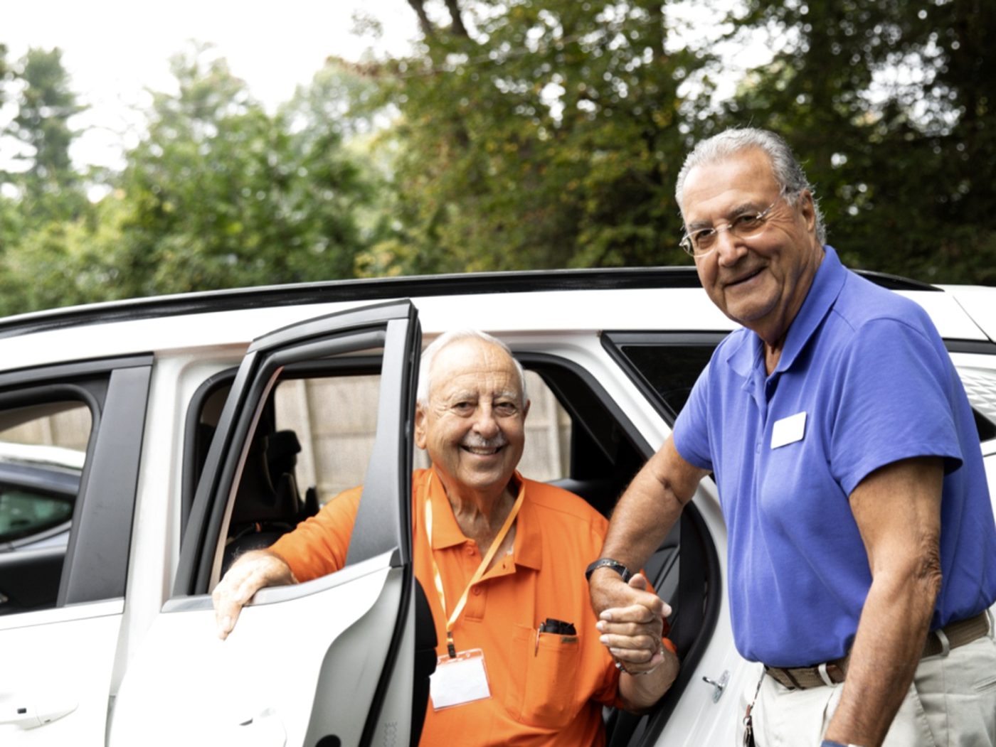 An Evergreen team member helping a member into the car for the ride home