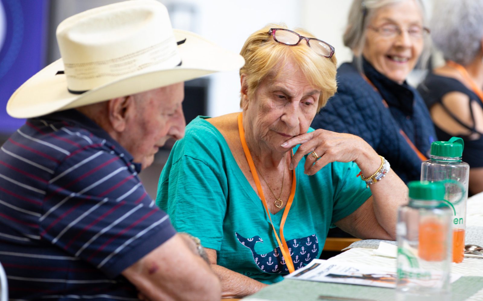 Evergreen members talking quietly around a table late in the day